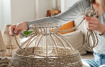 Woman makes handmade diy lamp from jute rope at home